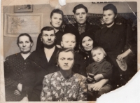 family photo of Kostelni family - from left to right: 3rd row: Anna (from Kostelni house, the narrator's sister), her husband - Dmytro Kish, sister Mariya Kostelna; 2nd row: neighbor, Mykhailo - father of the respondent, respondent, mother Kateryna (from Dembitski house), son of Hanna and Dmytro sitting in her arms; 3rd row - sister Ivanna Kostelna. Yuzhnaya mine, Prokopyevsk, Kemerovo region
