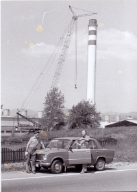 Men from Opatov near the cemetery, in the background the aluminum factory