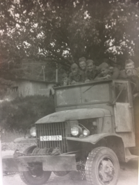 AEC members on the back of a truck, Lubomír Dvořák probably third from the right