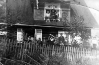 Ladislav Gavlas (on the shoulders of his older brother Antonín) in front of the family house, in the window his parents Pavel (in German uniform of a railwayman) and Johana, Mosty u Jablunkova - Filůvka, ca. 1939
