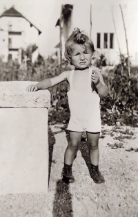 Little Natalija in front of her family home in Kranj, Slovenia, during the war
