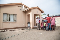 Mr Nepolo with his family in front of their house in Ongwediva