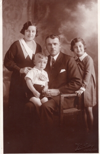 Binar's family. Mother, father, sister. Memorial sits on his father's lap. Year approx 1935.