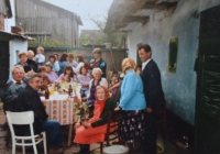 Gabrhel family reunion in Josef Gabrhel’s native house’s yard; his mother Irma Gabrhelová is seated, wearing a red dress