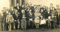 The witness's wedding photograph, from the left the groom's parents – Antonín and Růžena Ondroušek, above the bride the witness's brother Alois (he is pouring slivovice), the bride's parents Terezie and František Machač, the blurred woman on the far right is Anastázie Machačová (the bride's sister), 26th of February 1949 