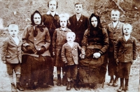 The witness’s great-grandmother Apolena and grandmother Františka, her father František as a boy standing in the middle at the back in a dark suit, undated