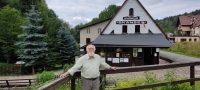 Bronisław Kamiński in front of the open-air museum in Pstrążna, which was established in Pstrążna in 1984. According to female witnesses, Pstrążna survived because the tourists from the Kudowa spa go there. Mr. Kamiński led it for five years (2005-2010)

