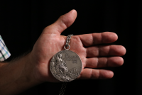 Vladimír Haber's hand with a silver medal from the 1972 Munich Olympics. 2022