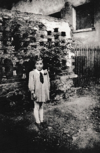 Karolina Remiášová as a little girl by a former farmhouse, replaced by a fire station later on