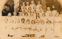 Karolina Remiášová with other girls and the parson during the first holy communion in the Chotěšov monastery, 1949