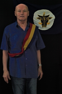 Vladimír Kříž in 2022 with a Hutt River sash and a flag of the Australian principality