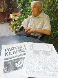Alexander Sola with copies of illegal leaflets from the 1980s.