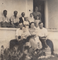 Deported Banat Czechs photographed in Comanesti. Sitting on the balcony, from the left: the Fikls’ neighbour Visket, Rudolf Fikl with wife, and Věra Jágrová and Margareta in the front. At the bottom, left to right: Feri Visket with child, Kristýna Fiklová with son Josef, and František Fikl. Comanesti, Romania, circa 1953