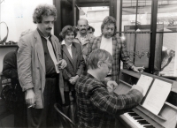 Richard Pogoda playing the piano at an exhibition at the Olomouc-based gallery Skácelík, standing above him Pavel Dostál (left) and Jan Kanyza (right), the 1990s