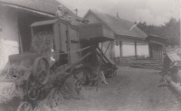 The family farm with a threshing machine