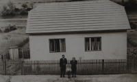Peter Rehák Jr. with his parents in front of his parents' house in Kubrica