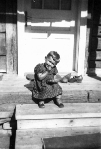 Zdeňka Rejhonová is sitting on the steps of a cottage at Bojkas in Carpathian Ruthenia