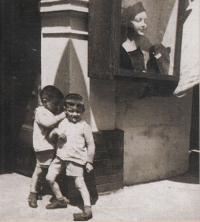 Twins Antonín and Zdeněk Hájek in front of their house, Masaryk Square No. 34 (today's Česká pojišt'ovna), Uherské Hradiště, 1941