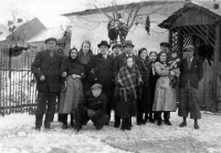 Marie Obrusníková with mother (cradling her), father (standing behind them) and the paternal side family, the grandparents Schwanczars, uncle Johan living in Germany, and father's brothers, 1937