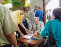 At a book signing in Křtěnov, he signs the book Faded Contours (about extinct villages near Temelín), 2008