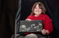 Libuše Vrtišková Hájková in the studio in 2024 with her photograph from Wenceslas Square during the Velvet Revolution in 1989