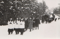 The front of the funeral procession going to the cemetery, with the coffin driven by two horses in the background. Emilie Zedníčková's husband, held in a communist prison at the time, was not released for her funeral in February 1952.