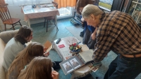 Arnošt Vošahlík shows photographs to pupils as part of the Stories of Our Neighbours project