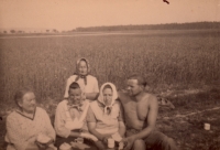 Father with women in the field, 1940s