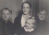 Brigitte Marks, about three years old, with her mother and older brothers