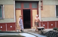 Parents clearing coal in front of their house in Žabčice, mid-1980s