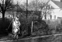 A neighbour in front of Adéla Lasáková's house in Oldřišov, probably 1970s