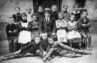 Adéla Lasáková's mother Marie née Flašková, top left above the teacher, school photo