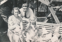 Jitka Režná (in her mother's arms) with her parents and sister Jana, who was celebrating her sixth birthday at the time, August 1954