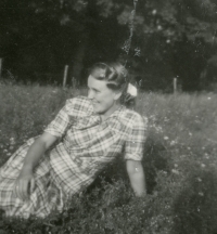 Cecílie Urbanec posing casually in the grass in 1953