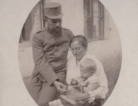 Family photo of grandfather with grandmother and witness's father, grandfather in uniform