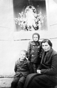 Miloslav Komárek standing with his mother at the forest chapel near Bochoř