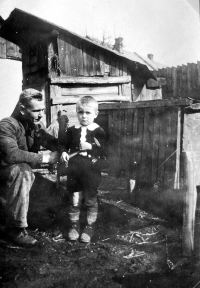 With his father in the yard of his family home in Včelin