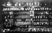 Interior of a glass and porcelain shop with a photograph of Klement Gottwald, 1950s