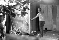 Erhard Pluške crushing bones to feed to hens in his backyard