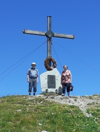 With husband in the Alps next to the memorial to the victims of war and combat at Schattberg West, Salzburg, Austria, 2025