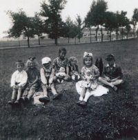 Arnošt Vošahlík (left) with friends from Buk near Milín, his sister in the middle with a doll