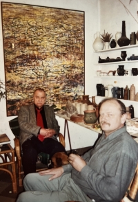 Jiří Načeradský sitting with Martin Zálešák under the painting Strniště