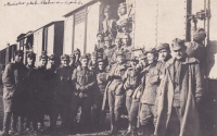 Military unit in front of the railway carriage on the way to the front