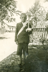 Vladimír Prejda's first Holy Communion during World War II, likely in 1941/1942. The Vrána family's house is in the background. The photo was taken in the place of today's passage to the houses past the municipal office in Uhlířov. On the far left was the former school, today's municipal office.