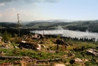 Spring aerial liming of the Souš Waterworks Reservoir in May 1996. The hollows on the left bank show places where there used to be a forest. Today, such a view is no longer possible - the forest restoration has been successful