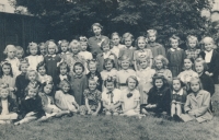 Jarmila Pribylová in first grade; back row, second left of the teacher with a bow