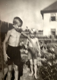 In front Josef Bartík with his friend and behind them their house, 1940s
