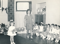 Viktoria in kindergarten with balloon and USSR flag