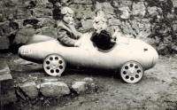 My father made a pedal car out of a spare air tank when he came home from the front. On the photo is the witness Karel Škarka with his sister Jana