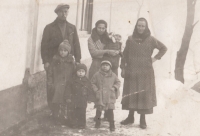 Witness in her mother's arms with her father and grandmother, 1933-1934